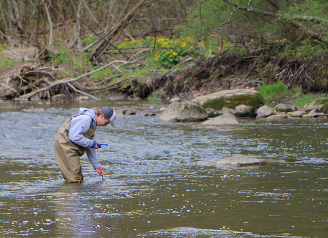 MUHS Student taking water sample